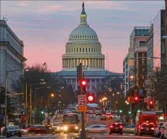  ?? Tasos Katopodis/Getty Images ?? The sun rises over the Capitol on Monday in Washington, D.C. President Donald Trump signed the coronaviru­s relief bill and government funding bill into law Sunday night.