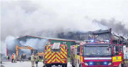  ?? Rob Browne ?? > Fire crews tackle the blaze at the Siteserve recycling factory in Llandow yesterday