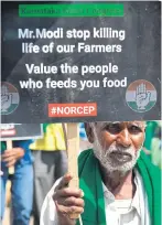  ?? AFP ?? An activist in Bangalore holds a placard protesting India’s inclusion in the RCEP.