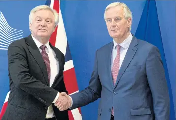  ?? AP ?? Chief Brexit negotiator Michel Barnier, right, shakes hands with British Secretary of State for Exiting the EU David Davis in Brussels.