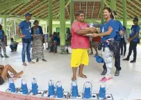  ??  ?? Community representa­tives receives Liter of Light in the Amazon.