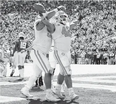  ?? Joe Robbins / Getty Images ?? Clemson’s Christian Wilkins (42) celebrates his touchdown in the second quarter against Florida State in Tallahasse­e, Fla. Clemson went on to hand the Seminoles their worst home loss in program history.