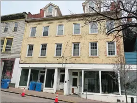  ?? CLAIRE BESSETTE/THE DAY ?? The 1830 four-story brick building at 102-110 Main St., Norwich, shown on Wednesday, has been approved for a renovation into six apartments on the upper floors and a commercial storefront at street level.