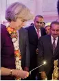  ?? — PTI ?? British Prime Minister Theresa May lights a lamp at a pre-Diwali reception with Indian entreprene­urs at 10 Downing Street in London on Monday.