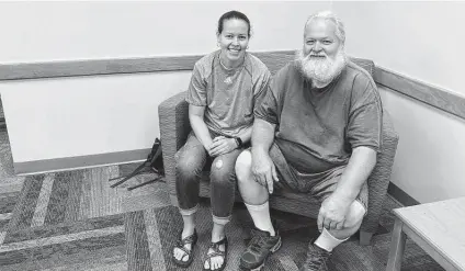  ?? Sarah Rankin / Associated Press ?? Ernest Ray sits with Kendra Potter, his niece, in August at the Virginia Higher Education Center in Abington, Va. Ray has been fighting the state in court as it tries to recoup unemployme­nt benefits he received after being laid off from his job.