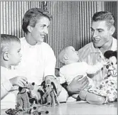  ?? Los Angeles Times ?? FAMILY MAN Ron W. Miller is shown in 1956 with wife Diane, daughter of Walt Disney, and two of their children. The couple met on a blind date and married in ’54.