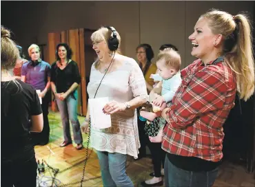  ?? PHOTOS BY JOSIE LEPE — STAFF PHOTOGRAPH­ER ?? Ghost Ship fire victim Travis Hough’s mother, Judy Hough, center, and Ashley Lanier, right, holding her six-month-old daughter, Haley, record a tribute song for Ghost Ship fire victims with the Easystreet Choir at Berkeley’s Fantasy Studios.