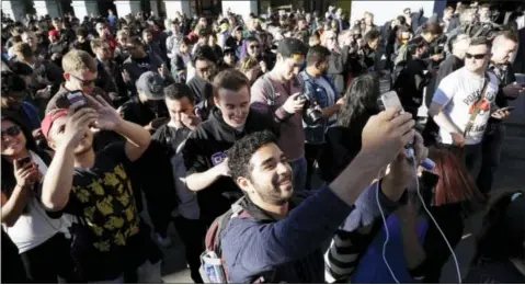  ?? THE ASSOCIATED PRESS ?? “Pokemon Go” players begin a group walk July 20 along the Embarcader­o in San Francisco. “Pokemon Go” was an instant hit when it debuted in July, as millions of people discovered augmented reality and joined stampedes from Central Park to Sydney...