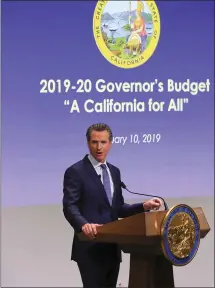  ?? JIM WILSON — THE NEW YORK TIMES ?? Gov. Gavin Newsom unveils his first state budget proposal on Thursday. In his inaugural address on Monday, he noted, “Even in a booming economy, there is a disquietin­g sense that things are not as predictabl­e as they once were, that we must now run faster just to stay in place.”