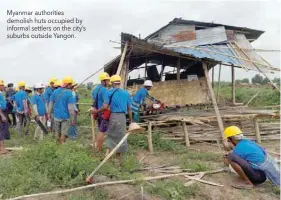  ??  ?? Myanmar authoritie­s demolish huts occupied by informal settlers on the city’s suburbs outside Yangon.