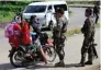  ?? - Reuters ?? SECURITY CHECK: Philippine National Police Special Action Force personnel man a checkpoint in Marawi city, as government troops continue their assault against insurgents from the Maute group, in Philippine­s on Saturday.