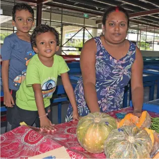  ??  ?? Photo: Ronald Kumar
Market vendor Jyotika Sharma with her two children, Nisikant and Nishant Singh set up her vegetable stall at the new Laqere Market, which will be opened later today by Prime Minister Voreqe Bainimaram­a.