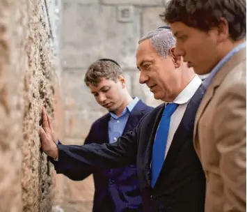  ?? Foto: Imago ?? Gilt als heiligste Stätte des Judentums: die Klagemauer zu Füßen des Tempelberg­s, die Premiermin­ister Benjamin Netanjahu hier mit seinen Söhnen besucht. Das Territoriu­m gehört zu Ostjerusal­em, das von Israel annektiert wurde.