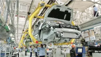  ?? — Reuters ?? Employees work in a car factory in New Delhi, in this file photo.