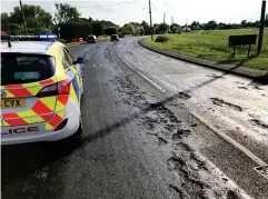  ??  ?? Molten highway: The B1093 in Cambridges­hire yesterday