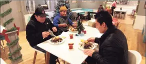  ?? Christian Abraham / Hearst Connecticu­t Media ?? Jacinto Andrade, left, has a pre-Christmas dinner with his son Diego and friend Jose Chavez at Mothership Bakery & Cafe in Danbury on Wednesday night.