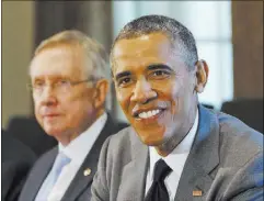  ?? JACQUELYN MARTIN/THE ASSOCIATED PRESS ?? President Barack Obama credited departing Democratic leader Sen. Harry Reid with helping him achieve what he did through his eight years as president.