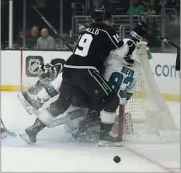  ?? ASHLEY LANDIS — THE ASSOCIATED PRESS ?? The Kings' Alex Iafallo (19) and the Sharks' Matt Nieto (83) collide at the goal next to Kings goaltender Cal Petersen, who made 29saves in L.A.'s 3-0victory.