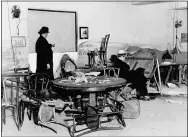  ?? STF ?? In this file photo, the wrecked speakeasy in the Hotel Victoria in mid-Manhattan, where Louis Levine, alias Louis Taylor, a small-time gambler, was killed by one of three gunmen earlier in the day in New York. A bystander points to a bullet hole in the wall, while another is seated in the chair where Levine, known as “Crooked Neck Louie,” was gambling when he was shot.