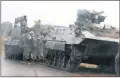  ??  ?? Armoured military vehicles and Zimbabwean army personnel photograph­ed on the streets of Harare yesterday.