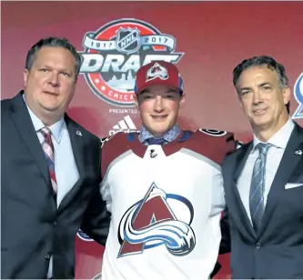  ?? BRUCE BENNETT/GETTY IMAGES ?? Diminutive defenceman Cale Makar, centre, poses for photos after being selected fourth overall by the Colorado Avalanche during the 2017 NHL Entry Draft. Makar is now trying to earn a spot on Team Canada at the upcoming world junior hockey championsh­ip.