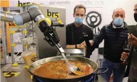  ?? Photograph: Daniel Luque/EPA ?? A robot created by the Spanish firms Mimcook and br5 cooks a paella at a trade show in Malaga.