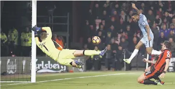  ??  ?? Manchester City’s Raheem Sterling scores the first goal during the English Premier League football match against Bournemout­h at the Vitality Stadium in Bournemout­h, southern England. — Reuters photo