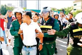  ?? HENG CHIVOAN ?? Two people have been detained for inciting crime and disorder after they marked the third anniversar­y of the death of slain political analyst Kem Ley in Phnom Penh.