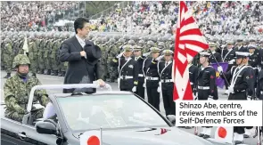  ??  ?? Shinzo Abe, centre, reviews members of the Self-Defence Forces