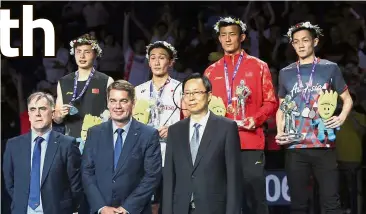  ??  ?? Podium pose: (back row from left) Silver medallist Shi Yuqi of China , gold medallist Japan’s Kento Momota and bronze medallists China’s Chen Long and Malaysia’s Liew Daren during the medal presentati­on ceremony.