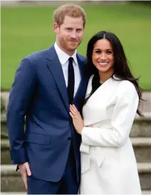  ??  ?? Britain's Prince Harry with his fiancee US actress Meghan Markle. (AFP)