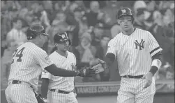  ?? SETH WENIG/AP ?? The Yankees’ Aaron Judge, right, celebrates with teammates after scoring against the Twins in the third inning of Game 2 on Saturday.