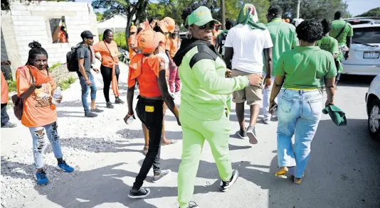  ?? PHOTO BY RICARDO MAKYN / MULTI MEDIA PHOTO EDITOR ?? Supporters of the PNP and the JLP seen at the Yallahs Primary School, St Thomas, on nomination day.