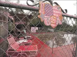  ?? Luis Sinco Los Angeles Times ?? A HOME SWIMMING POOL is covered in fire retardant Friday near Hemet. About 24,000 people were under evacuation orders as the Fairview fire spread.