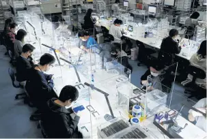  ?? ?? LEFT iPhones are cleaned at a Belong operations centre, in Zama, Kanagawa Prefecture, Japan.