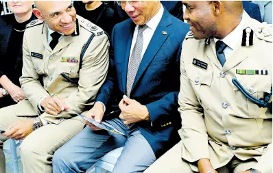  ?? RUDOLPH BROWN/ PHOTOGRAPH­ER ?? Dr Horace Chang (second right), deputy prime minister and minister of national security, chats outgoing Commission­er of Police Major General Antony Anderson (second left) and new Commission­er of Police Dr Kevin Blake at the Jamaica Constabula­ry Force’s Change of Command ceremony at the Office of the Commission­er of Police on Old Hope Road in Kingston yesterday. Sitting to Anderson’s left is Justine Henzell.