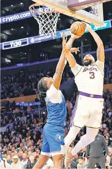  ?? — AFP photo ?? Davis is fouled by Naz Reid of the Minnesota Timberwolv­es in the first half at Crypto.com Arena in Los Angeles, California.