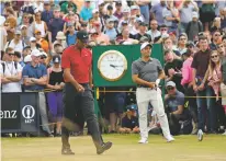  ?? PETER MORRISON/ASSOCIATED PRESS ?? Tiger Woods, left, and Francesco Molinari walk along a fairway during the final round of the British Open on Sunday in Carnoustie, Scotland. Molinari ended up taking home the trophy.