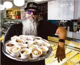  ?? Brett Coomer photos / Houston Chronicle ?? Lee Ellis displays his ice cream creations, which include strawberry cheesecake and sweet corn.