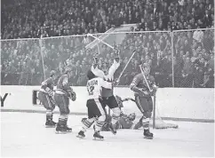  ?? LIBRARY AND ARCHIVES CANADA ?? Paul Henderson’s iconic winning goal in Game 8 of the 1972 Summit Series with Yuri Lyapkin on the right.
