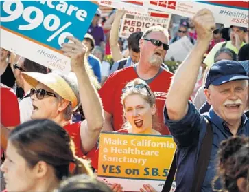  ?? Jay L. Clendenin Los Angeles Times ?? A SINGLE-PAYER SYSTEM of healthcare in California, supported by demonstrat­ors May 19 in Sacramento, is one small step closer to reality. A proposal cleared the Senate on Thursday, but it faces many hurdles.