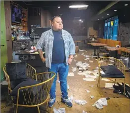  ?? Jason Armond Los Angeles Times ?? ALBERTO MENDEZ, owner of El Zarape, stands in his restaurant on Wednesday. “The minute I got there I was in shock,” he said. No arrests have been made.