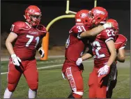  ?? BEA AHBECK/NEWS-SENTINEL ?? Lodi's Alfredo Estrada (31) and lineman Ethan Bronson (71) congratula­te Angelo Zazzarino (22) on his touchdown during a game against Sonora in Lodi on Sept. 1