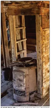  ??  ?? A wood stove sits in a nook between the two downstairs rooms.