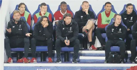  ??  ?? Liverpool manager Jurgen Klopp (left), players and staff sit dejected on the bench during the Carabao Cup match at the King Power Stadium, Leicester.