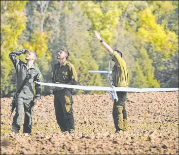  ?? Ariel Schalit The Associated Press ?? Israeli soldiers operate a drone near the Israeli-gaza border in southern Israel on Wednesday. The Israeli military struck Rafah in southern Gaza twice overnight.