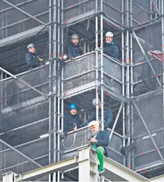  ??  ?? Ben Atkinson scaled scaffoldin­g on the Elizabeth Tower while dressed as Boris Johnson