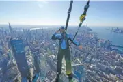  ?? AP PHOTO/SETH WENIG ?? Climb guide Jason Johnson leans off the edge at the top of City Climb, a new attraction at 30 Hudson Yards, in New York on Nov. 3.