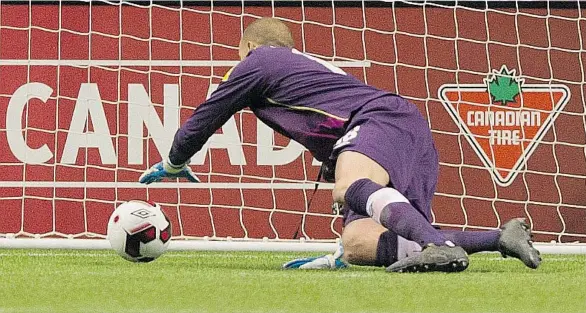  ?? GERRY KAHRMANN / PNG ?? Canada goalkeeper Milan Borjan reaches back for a loose ball during play against Milan Borjan of Mexico during Friday’s FIFA World Cup soccer qualifier at BC Place. Canada lost this game, but still has another chance to qualify when it plays Tuesday in Mexico City.WORLD CUP QUALIFYING | MEXICO 3, CANADA 0