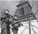  ?? BENOIT TESSIER/REUTERS ?? French soldiers patrol at the Eiffel Tower on Monday in Paris. France raised its terror alert to its highest level following Friday’s shooting in Moscow.